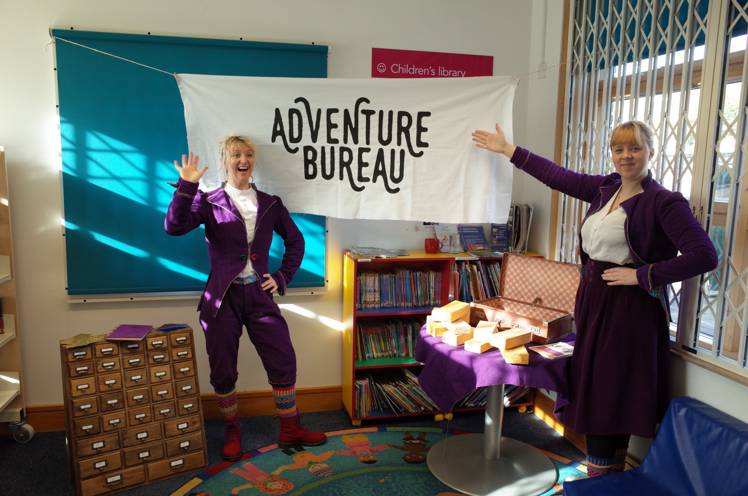 Two Adventure Bureau Storymakers with workshop equipment in a library